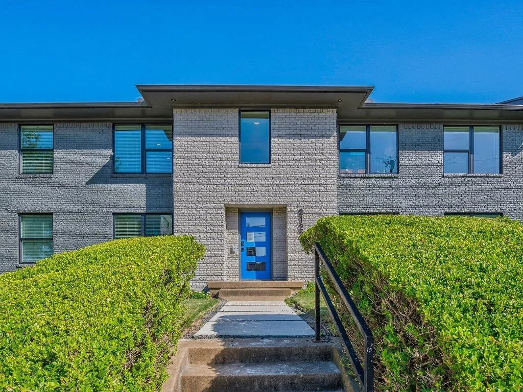 White Rock Views apartment exterior with a blue entry door