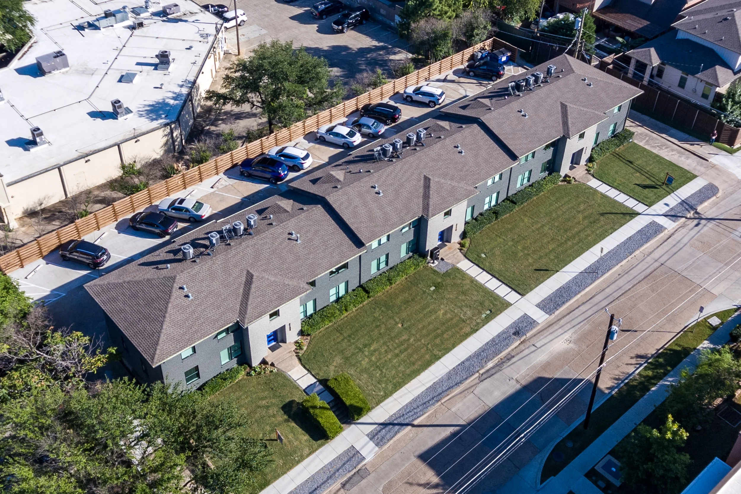 Angled aerial of White Rock Views buildings, front lawns and surrounding street